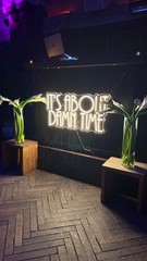 “It’s about damn time” neon sign