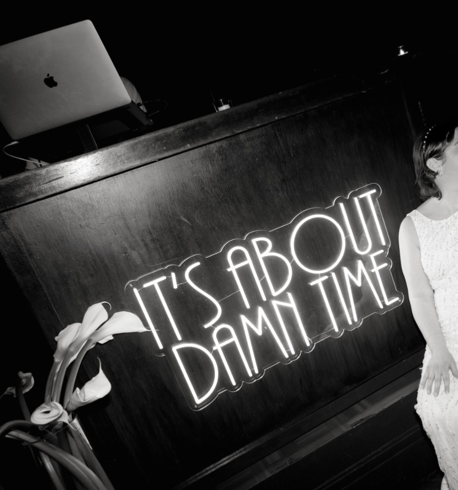 “It’s about damn time” neon sign