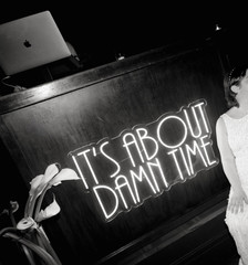 “It’s about damn time” neon sign