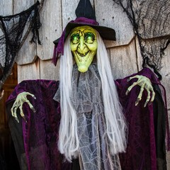 Morris Costumes 4 ft Hanging Animated Witch with Green Eyes Decoration – Black