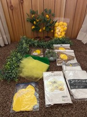 Lemon first birthday decor, garland, paper fans, fake lemons, limes & lemon tree