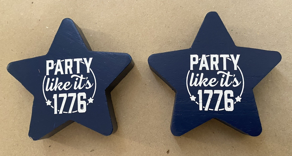 Two “Party Like It’s 1776” wooden star-shaped party decorations