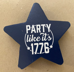 Two “Party Like It’s 1776” wooden star-shaped party decorations