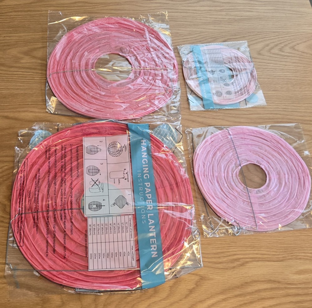 Set a four pink paper lanterns- 12, 10, 8, and 6 inch, various shades