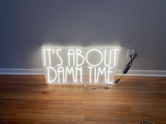 “It’s about damn time” neon sign
